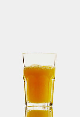 Image showing Glass with orange juice on the white