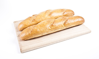 Image showing fresh baguette on wooden plate