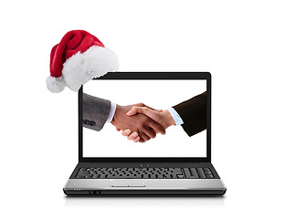 Image showing Business people shaking hands in laptop