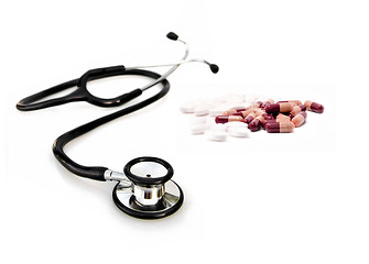 Image showing doctors stethoscope with pills