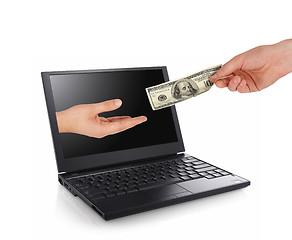 Image showing hand giving some money from a laptop