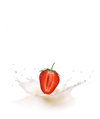 Image showing Splash of milk, caused by falling into a ripe strawberry