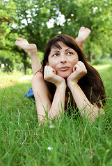 Image showing Woman portrait lying in grass dreaming