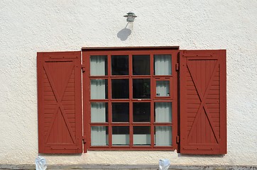 Image showing Red window on white wall