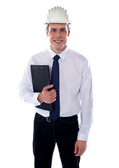 Image showing Young architect holding clipboard