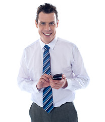 Image showing Smiling business professional messaging