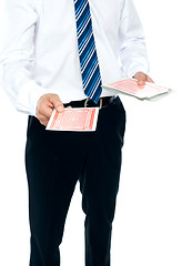 Image showing Cropped image of a man holding playing cards