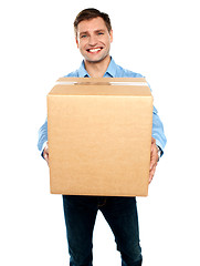 Image showing Casual guy carrying packed cardboard boxes