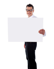 Image showing Smiling guy holding banner ad with one hand