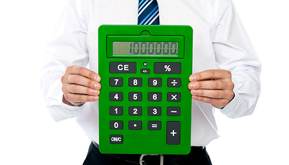 Image showing Closeup of a green calculator. Man holding it