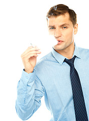 Image showing Young businessman smoking cigarette