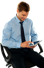 Image showing Businessman watching videos on tablet pc