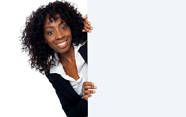 Image showing Businesswoman holding a long blank banner ad