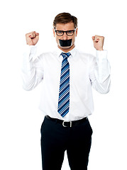 Image showing Angry young man with duct tape on his mouth