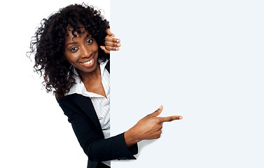 Image showing Female representative pointing towards placard