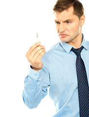 Image showing Angry smoker staring at cigarette