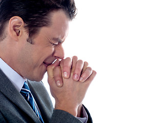 Image showing Business executive praying to god