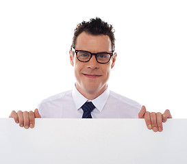 Image showing Young man holding blank billboard