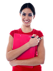 Image showing Pretty teenager holding folder and pen
