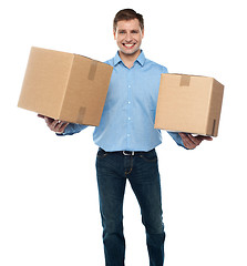Image showing Portrait of a guy holding boxes