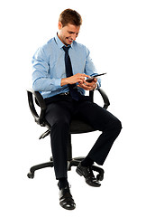 Image showing Full length shot of seated entrepreneur