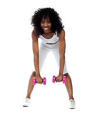 Image showing Fit woman exercising. Bending down