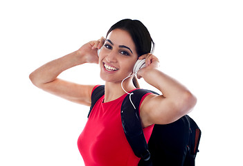 Image showing Trendy casual girl listening to music