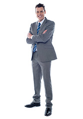 Image showing Businessman standing with arms crossed