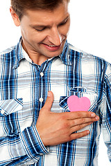 Image showing Handsome man holding paper heart