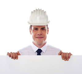 Image showing An architect holding blank white placard