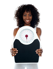 Image showing African athlete showing weighing scale