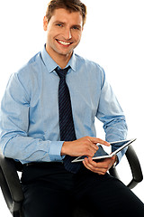 Image showing Relaxed businessman using tablet pc
