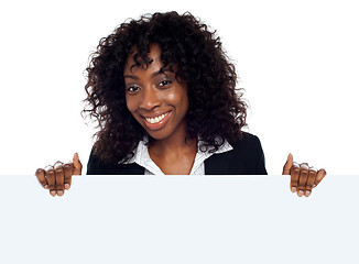 Image showing Young woman holding blank white placard