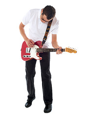 Image showing Casual man with guitar looking down