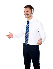 Image showing Smiling male operator explaining discounted offer