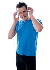 Image showing Attractive guy holding headphones