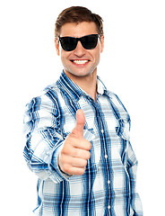 Image showing Smart young guy showing thumbs up