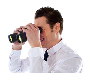 Image showing Male executive looking through binoculars