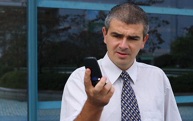 Image showing Checking the mobile phone display