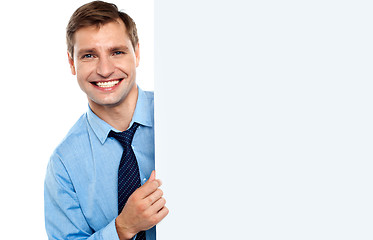 Image showing Business man holding a long blank banner ad