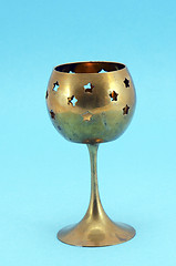 Image showing Bronze glass candlestick on blue background 