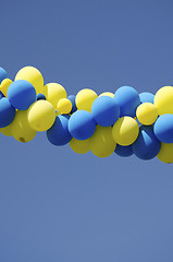 Image showing Yellow blue color balloons on background blue sky 