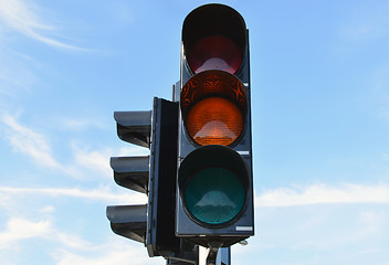 Image showing Yellow color traffic light blue sky in background 