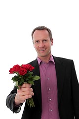 Image showing Man gives red roses