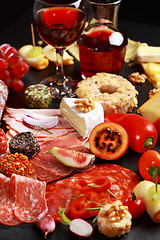 Image showing Antipasto catering platter with red wine