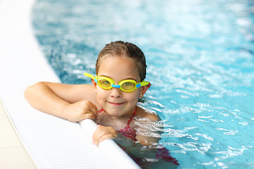 Image showing Schoolgirl with goggles in swimming pool