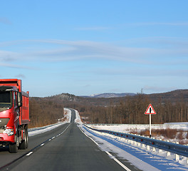 Image showing The red truck on a winter road.