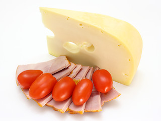 Image showing Cheese with holes and red tomatoes 