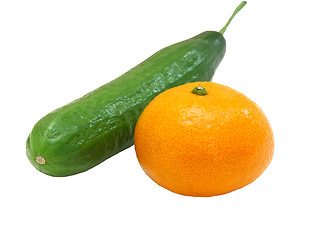 Image showing The fresh green cucumber with a tangerine 