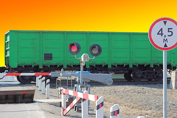 Image showing railroad cars at the crossing with a barrier